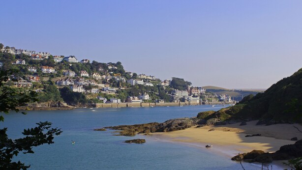 A coastal town with houses on a hillside, a sandy beach, and calm waters. - 3 Melbury (Salcombe)