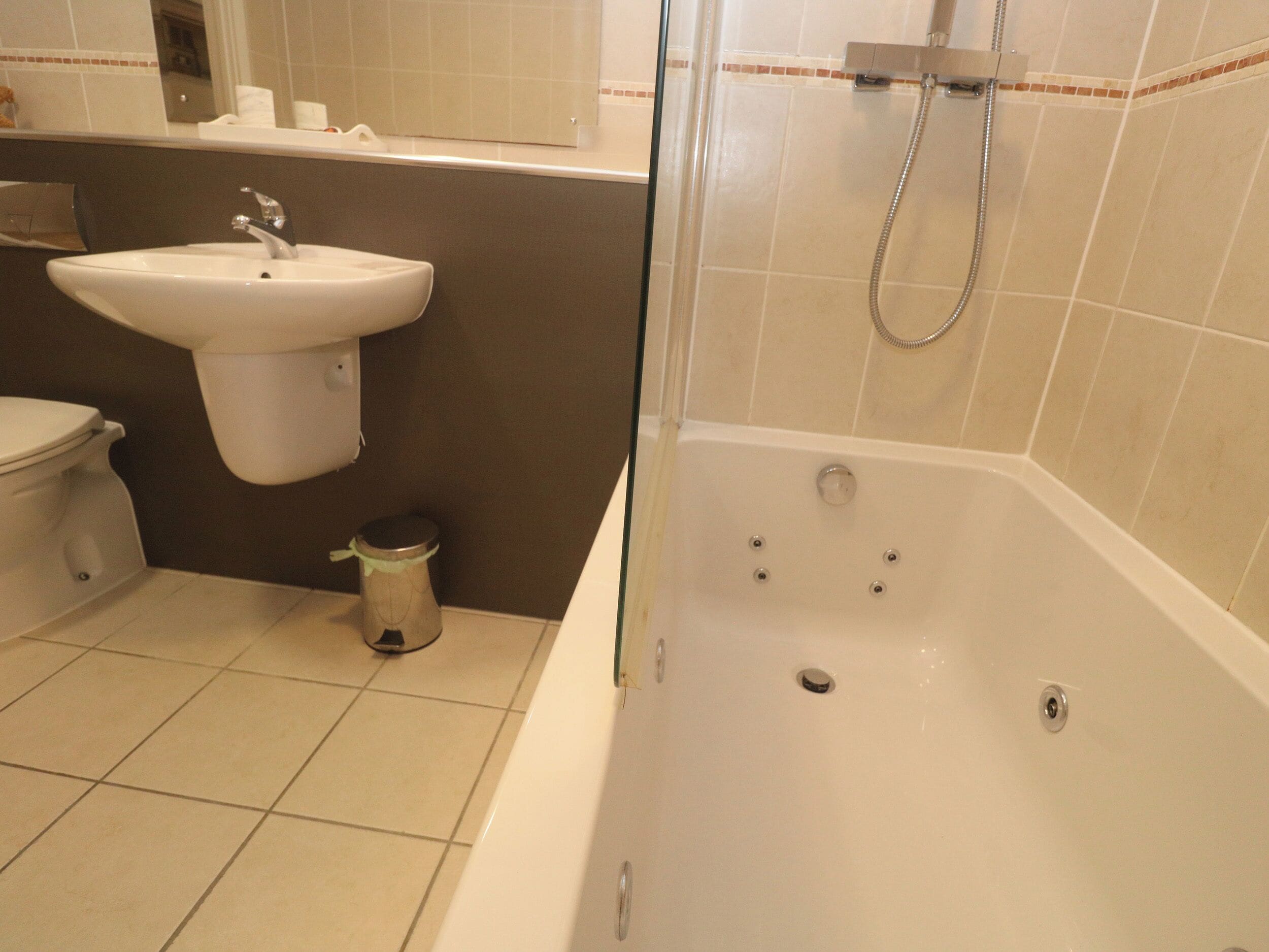 A bathroom with a toilet, sink, and bathtub.