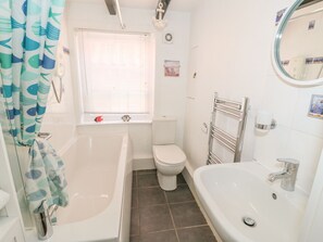 Ein Badezimmer mit einer Badewanne, Toilette und Waschbecken.