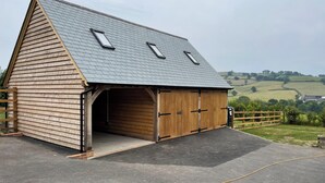 A wooden barn with a sloped roof and two skylights. - Culverwells (Axminster)