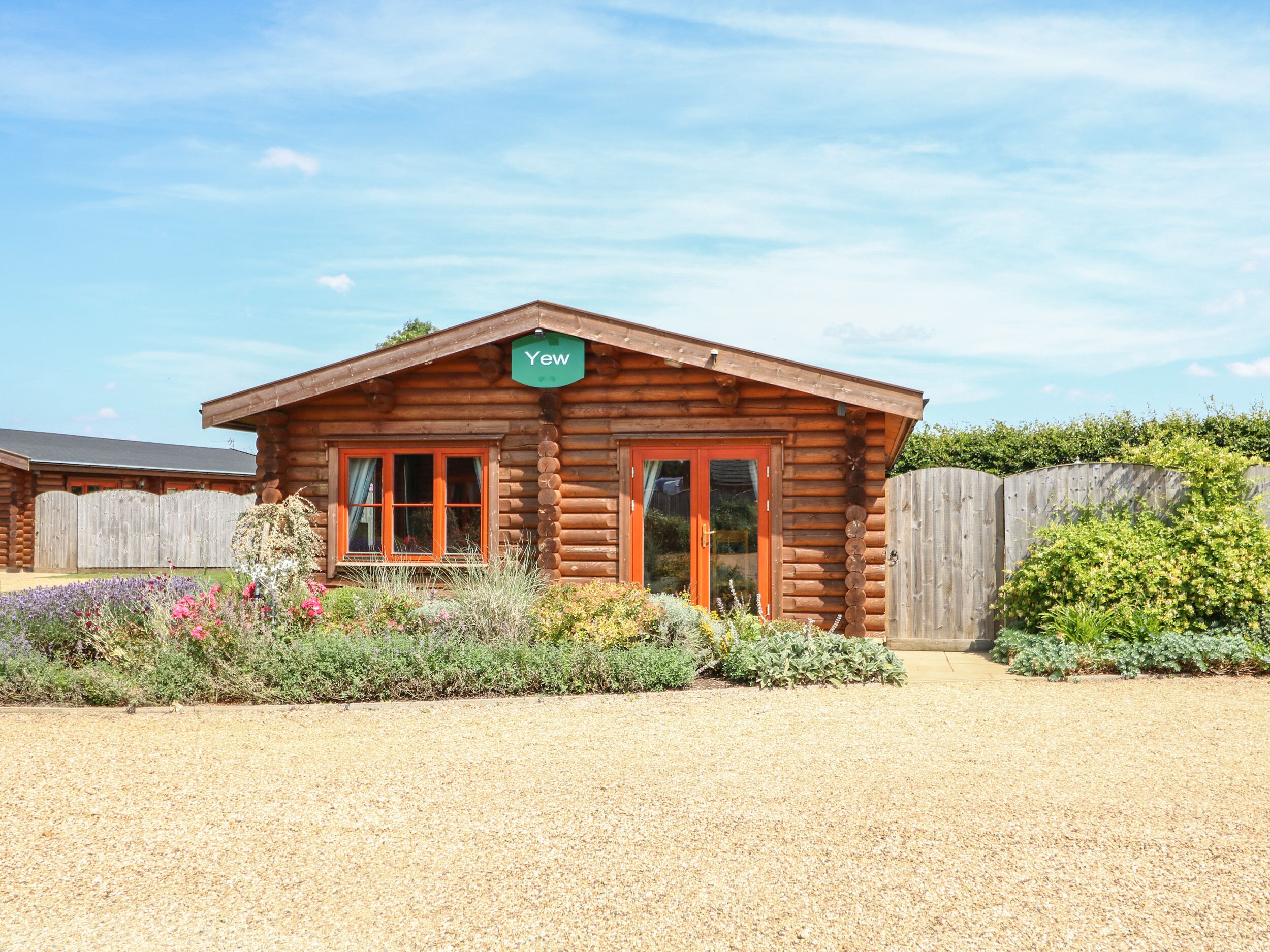 A wooden cabin with a sign reading "Yew."