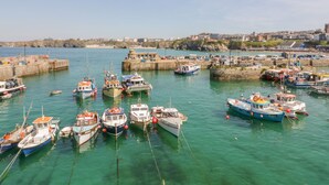 A harbor with numerous boats docked at piers. - Onshore 7 (Newquay)