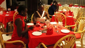 A dining area with red tablecloths and wicker chairs. - Garden Hotel (Machakos)