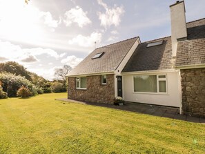 Set amidst a serene and garden, this two-story house offers a peaceful retreat.