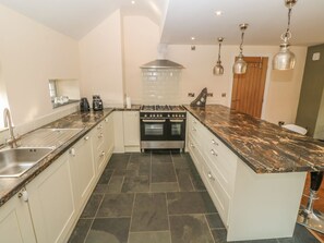 Enjoy cooking in this well-equipped kitchen with a central island, oven, and gas stove.