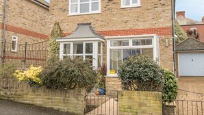 A two-story brick house with a bay window and a small conservatory. - Casa Carmen (Weymouth)