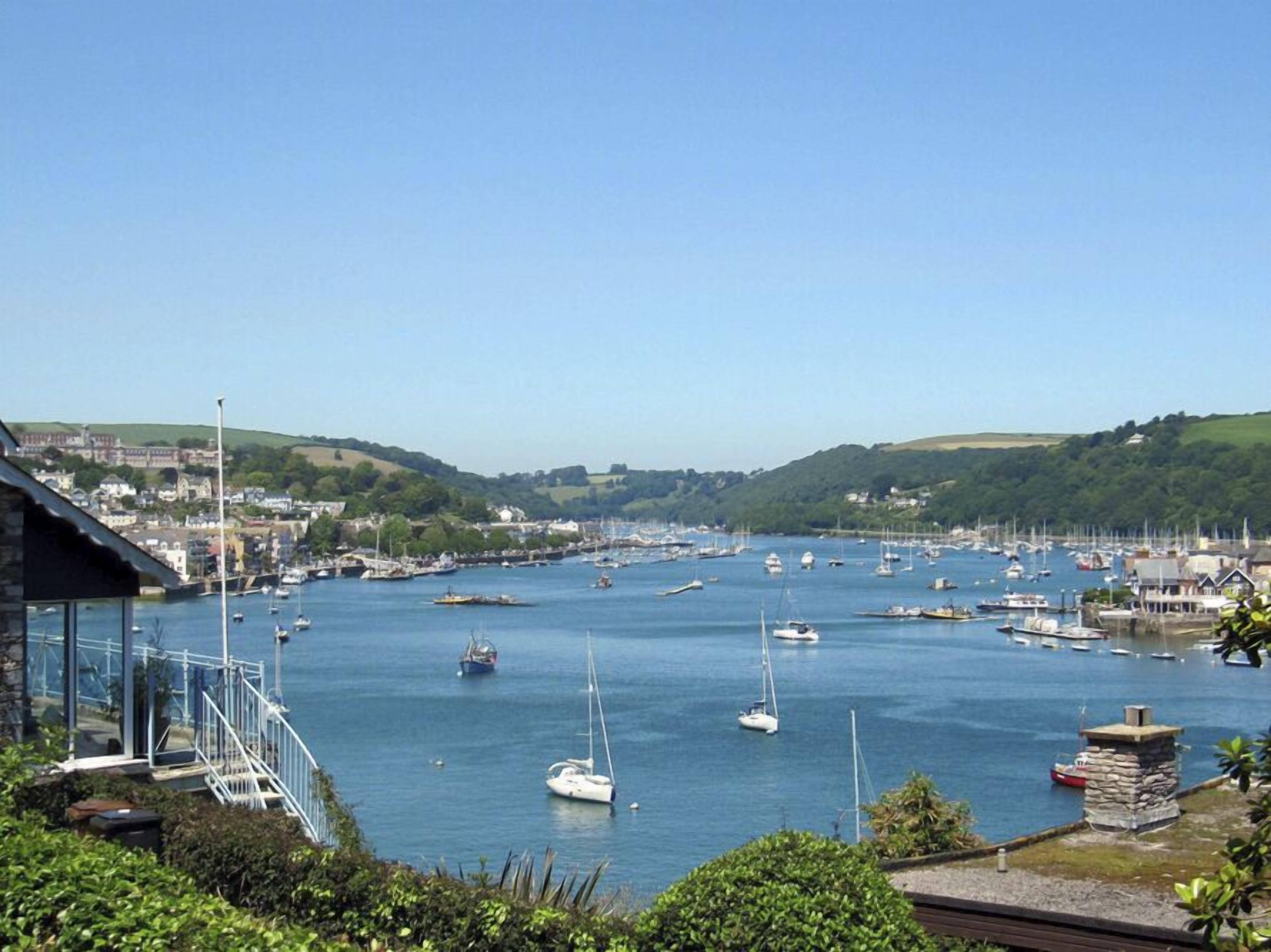 A harbor with boats and a town in the background.