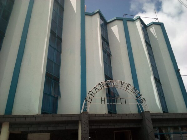 A hotel entrance with a sign reading "GRAND HOTEL."