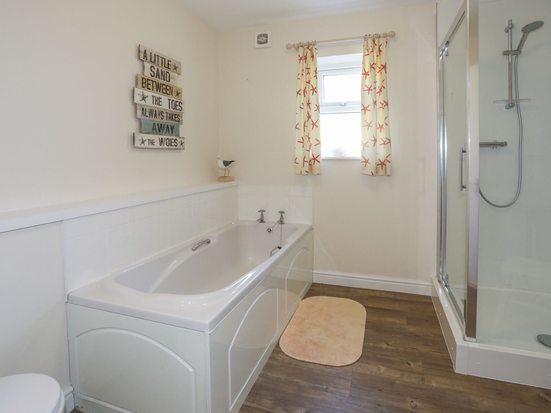A bathroom with a bathtub, a shower, and a toilet.