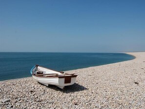 A boat on a pebbled beach with a clear view of the sea. - St Johns View (Portland)