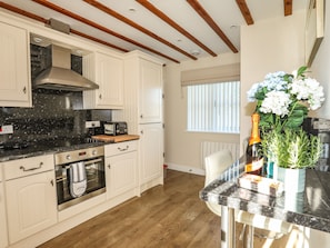 Enjoy cooking in this well-equipped kitchen with an oven, stainless steel range hood, and toaster.