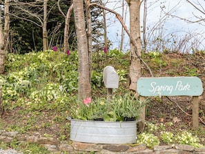 A mailbox, a sign reading "Spring Park," and a planter with various plants. - Spring Park Farmhouse (Launceston)