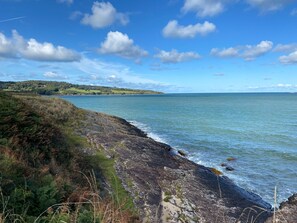 Enjoy a serene coastal escape with a gentle slope leading to the calm sea.