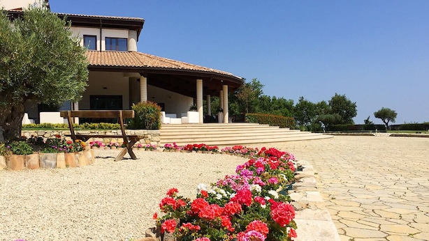 A two-story house with a tiled roof, a covered porch, and a gravel driveway. - Parco delle Stelle (Castelmauro)