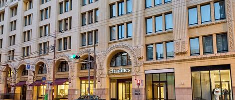 A multi-story building with a classic architectural style, featuring arched windows and decorative moldings.