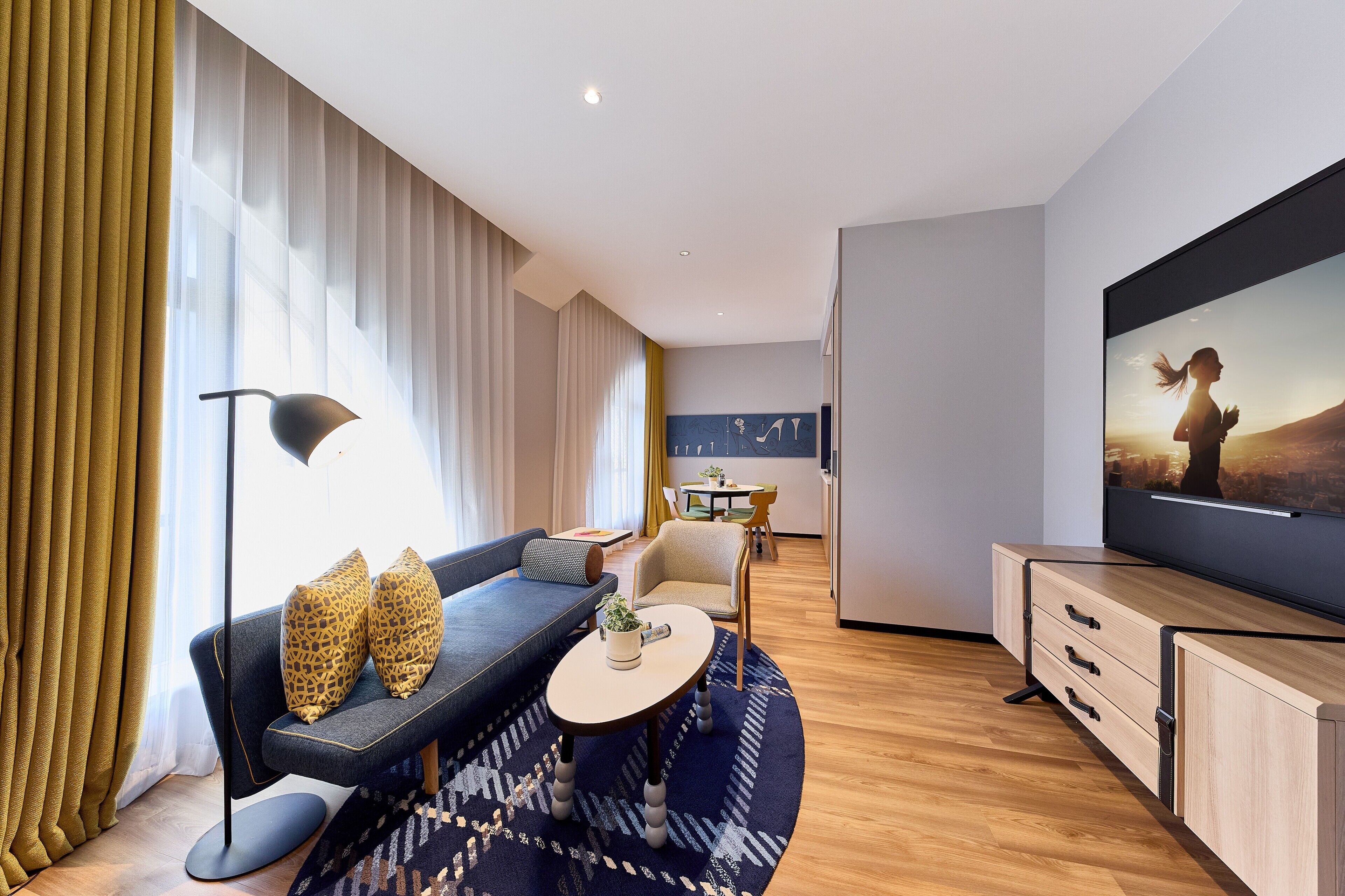 A modern living room with a sofa, coffee table, and TV.