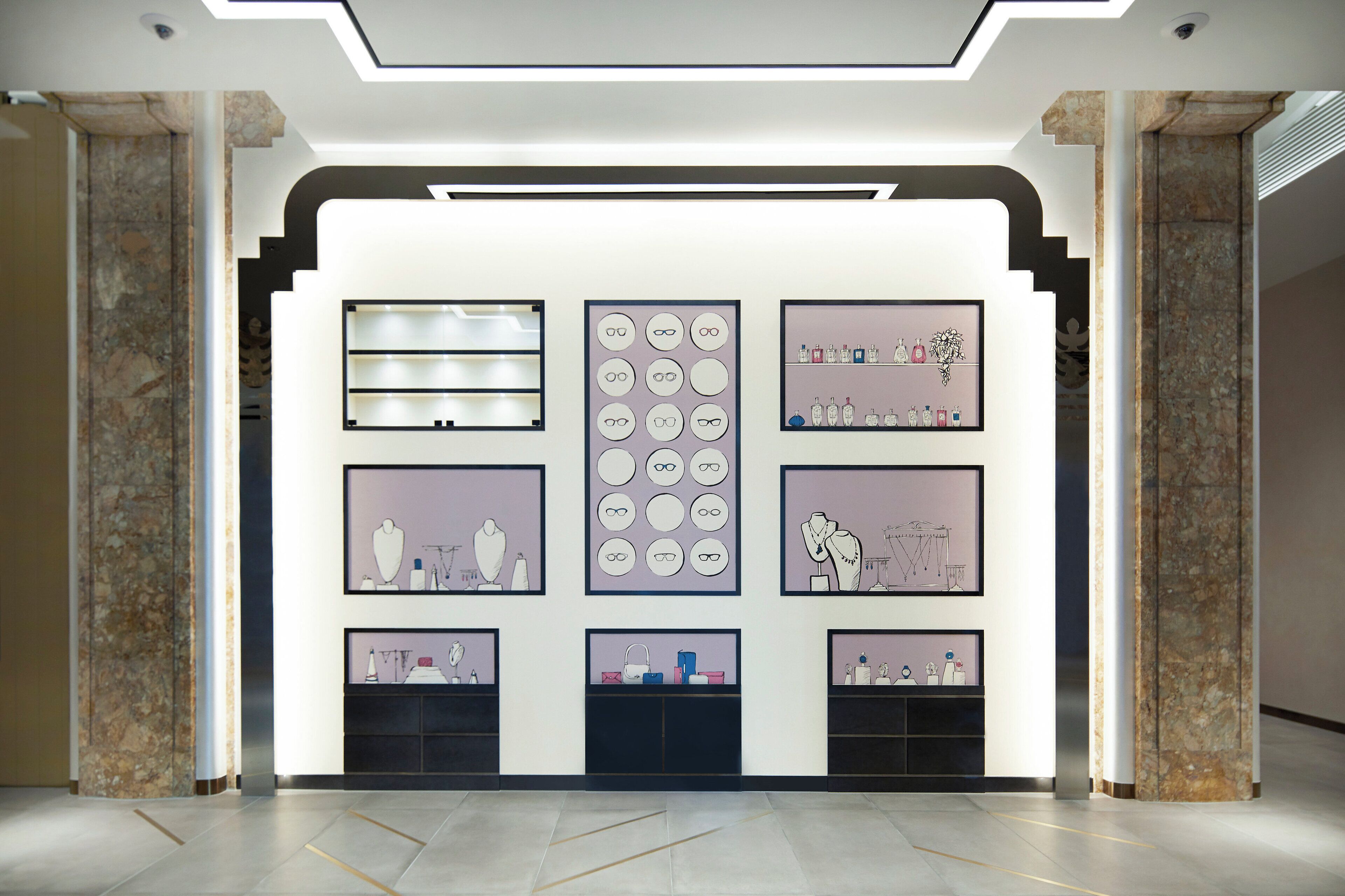 A modern interior with a central display of framed artwork and a clean, minimalist design.