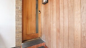 A wooden door with a glass panel and a doorbell. - Underfell (Carnforth)
