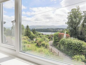 Guests can enjoy a serene view of the lush garden and surrounding hills from the comfort of their room.