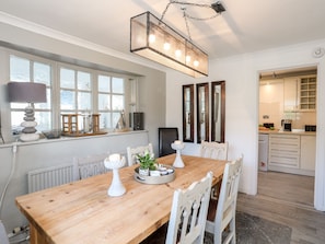 Enjoy meals in this well-appointed dining area with a table for four, surrounded by ample natural light and stylish decor.