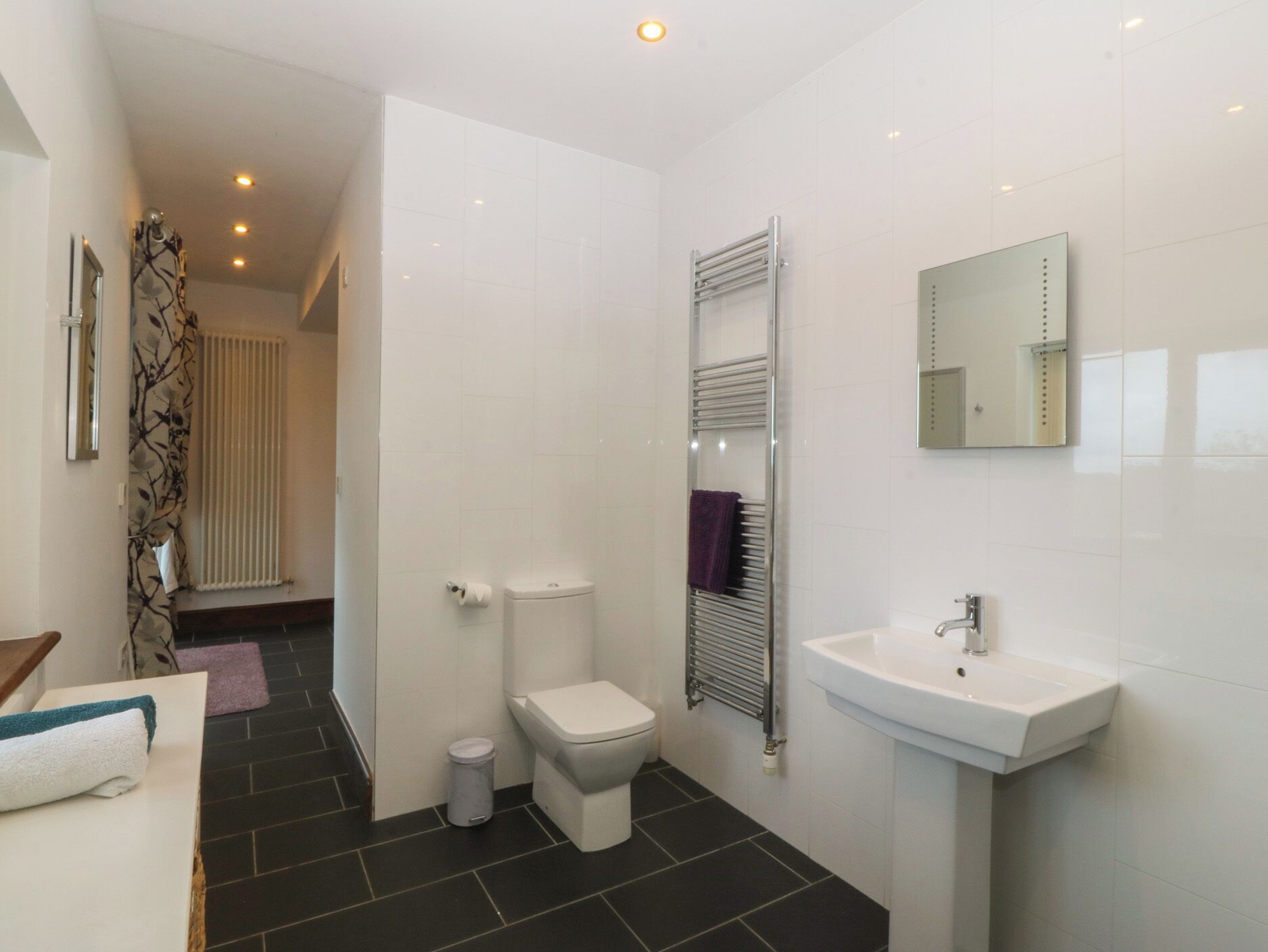 A modern bathroom with a toilet, bidet, and sink.