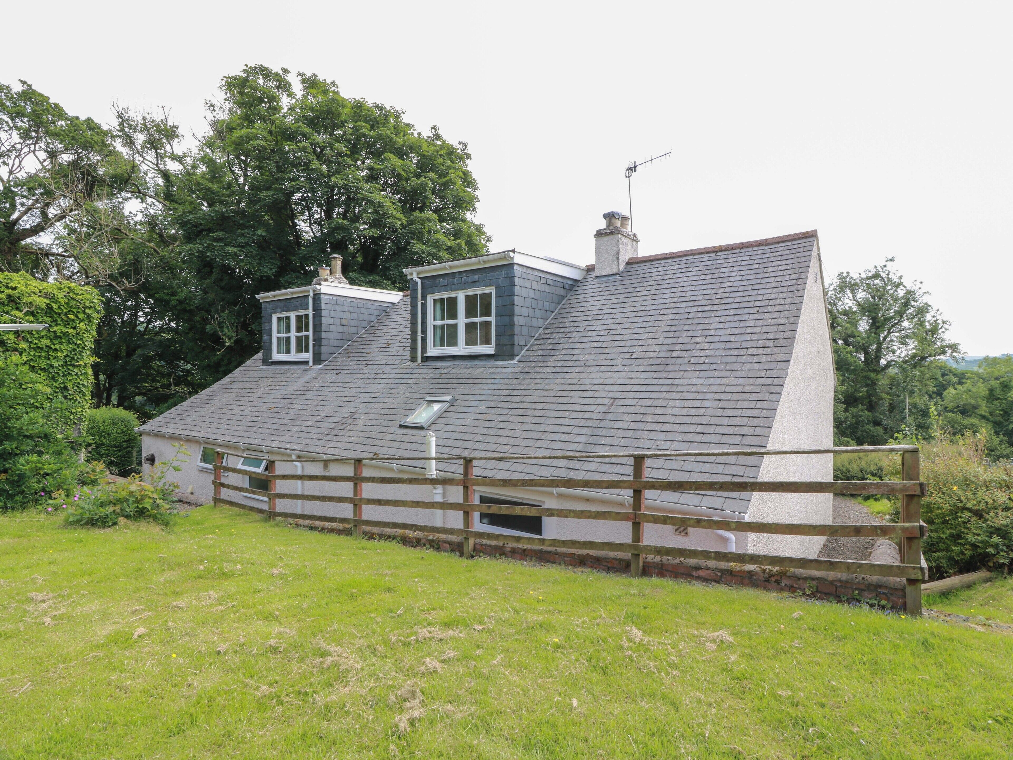 A house with a sloped roof, two windows, and a chimney.