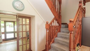 A wooden staircase with carpeted steps leading to a landing. - Beggars Roost (Truro)