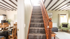 A staircase with a wooden handrail leading to a landing.