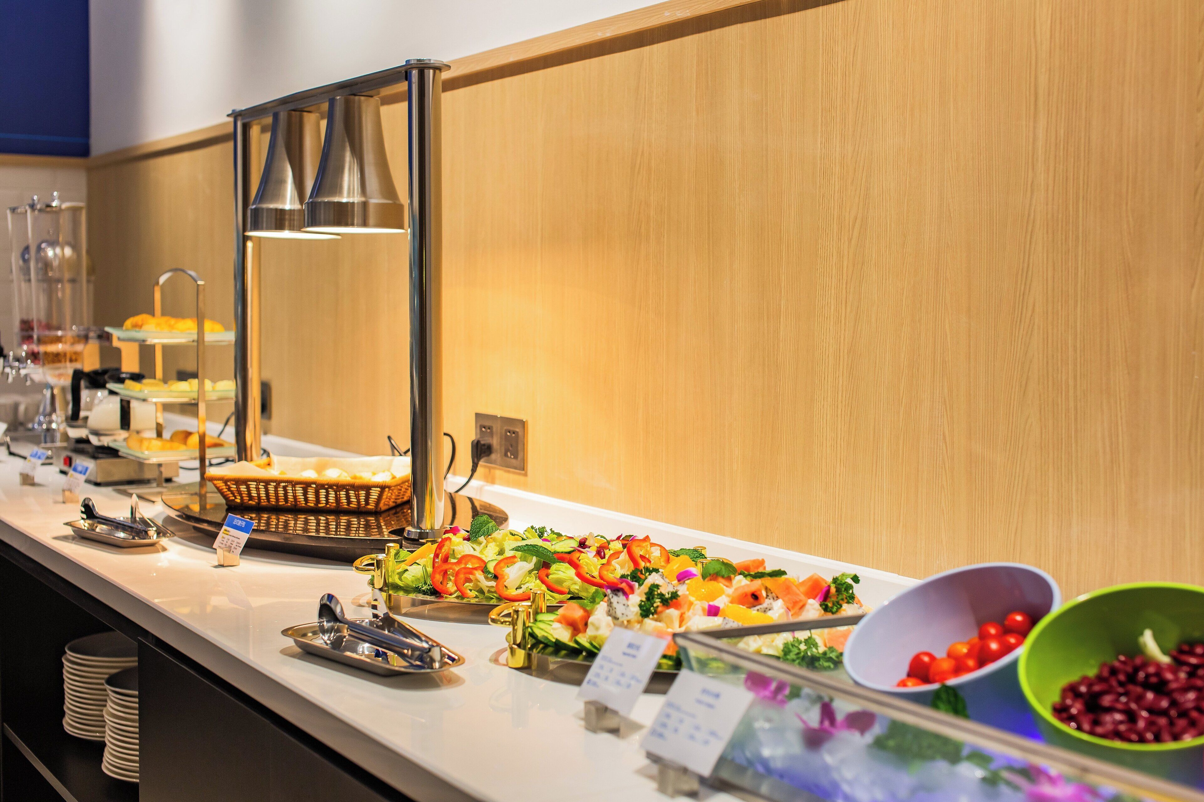 A buffet setup with various food items and a beverage station.