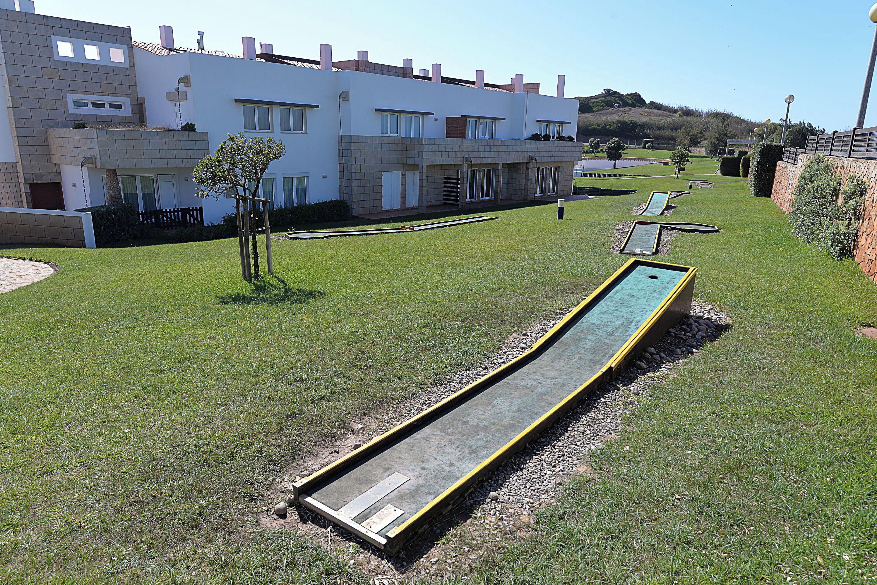 A modern building with a flat roof and multiple windows.