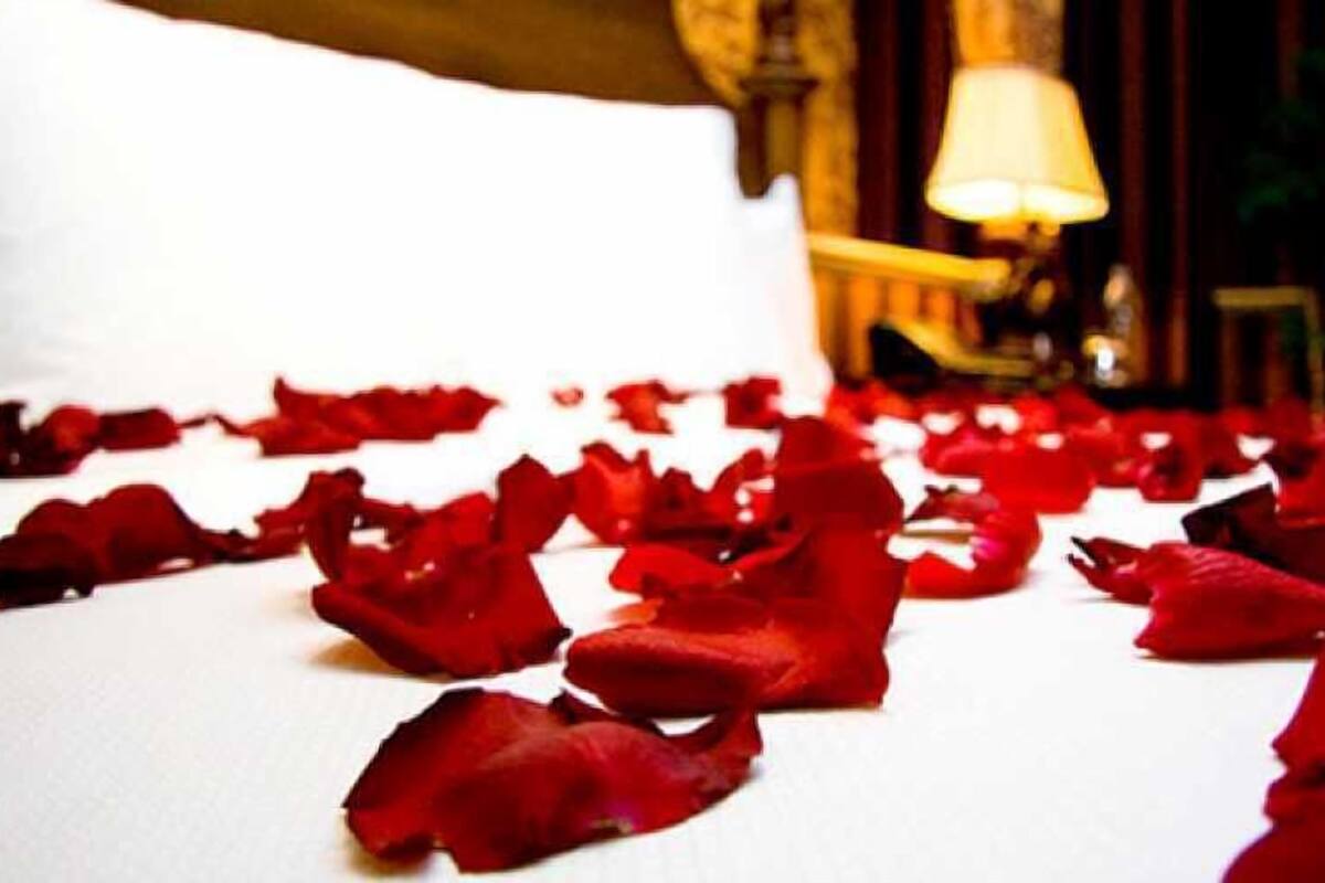 A room with scattered rose petals on the floor.