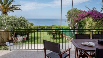 Relax on the balcony with a serene sea view, enjoying a meal or a good book in a peaceful outdoor space.