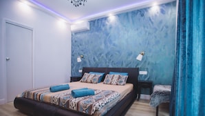A modern bedroom with a large bed, a nightstand, and a chair. - Villa Marghareta - Deluxe App Marghareta (Dubrovnik)