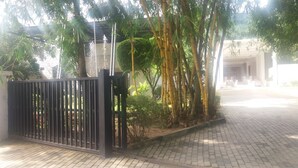 A gated entrance with a paved pathway leading to a building. - Hotel Asliya Regency (Mawathagama)