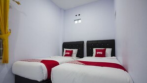 A hotel room with two beds, each with a black headboard and white bedding. - Hotel O Sopou Penginapan Rinal & Tuah (Bahapal Raya)