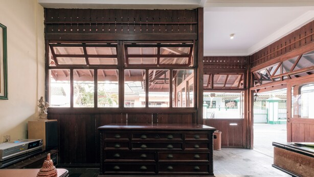Un interior tradicional de madera con un gran aparador de madera y un televisor sobre una mesa.