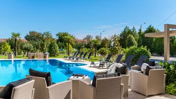 Outdoor pool, open 6:00 AM to midnight, pool umbrellas, pool loungers