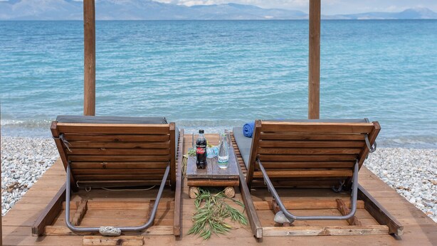 Di pantai dan kursi berjemur