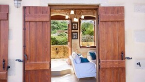 A doorway leading to a room with a white sofa and a window. - Villa Patriko Lux villa with pool next to Balos (Kissamos)