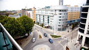 En flervåningsbyggnad med modern design, som har en central rondell och en gångväg för fotgängare.