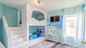 A bedroom with a bunk bed, a desk, a window with curtains, and a staircase. - Themed 7 Bedroom Villa, 12 Min to Disney, Resort Access (Kissimmee)