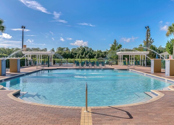 A large outdoor swimming pool with multiple lounge chairs and a gazebo. - 4 Bedroom Townhouse, Resort, 15 Mins to Disney, Themed Rooms perfect for Kids (Kissimmee)