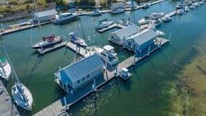 A marina with multiple docked boats and a few small buildings. - BAYDREAM - Peaceful! Inviting! Clean! Floating quiet getaway! Dock your boat!! (Pensacola)