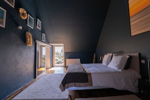 Quarto com cama, janela e porta para o exterior.