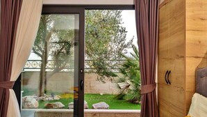 A bedroom with a sliding glass door leading to a garden. - Villa Arbanessa with Heated Pool (Arbanija)
