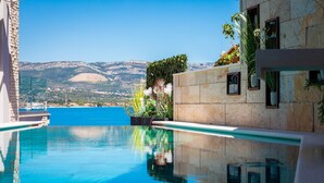 A clear blue pool with a view of the sea and mountains in the background. - Villa Arbanessa with Heated Pool (Arbanija)