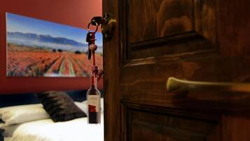 A wooden door with a keyhole and a keychain with a wine bottle.