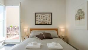 A hotel room with a large bed, two bedside tables, a framed picture of buildings on the wall, and a balcony with a railing. - San Lorenzo Terrace Duomo View, near the SMN station, Tram, Market. AC provided (Firenze)