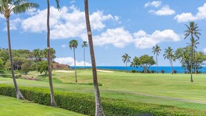 A golf course with palm trees and a view of the ocean. - Remodeled Studio w AC Pool & Exclusive Beach Cabana - Maui Eldorado J222 (Lahaina)