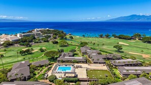 A golf course with a swimming pool and a view of the ocean. - Remodeled Studio w AC Pool & Exclusive Beach Cabana - Maui Eldorado J222 (Lahaina)
